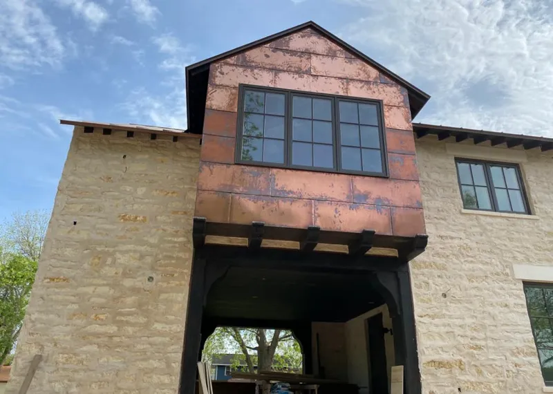 Copper metal panel facade on a stone building for Roof Repair in Pullman